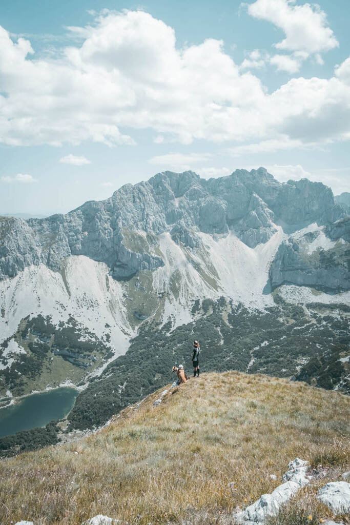 un homme et un chien dans les montagnes au sommet du mont Prutas au Monténégro